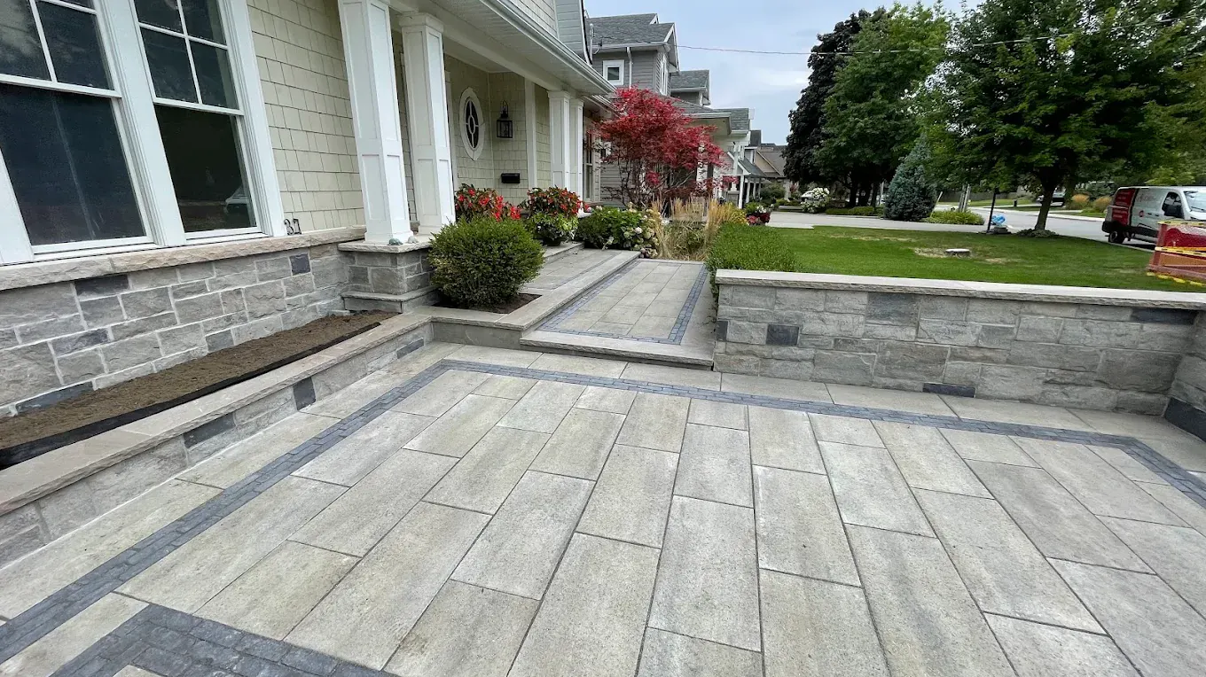 Completed interlocking front entrance with stone retaining wall